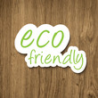 Eco friendly sign on wooden background