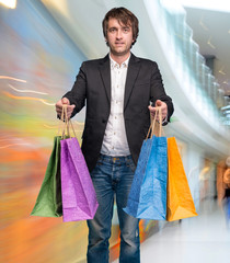 Handsome young man with shopping bags