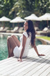 © XtravaganT - Smiling Indian Woman Relaxing at the Poolside