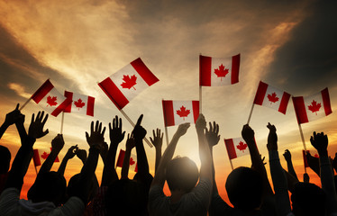 group of people waving canada flags