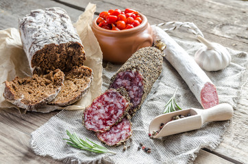 Wall Mural - Slices of saucisson and spanish salami on the sackcloth