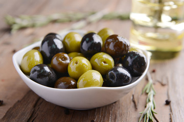 Wall Mural - Different marinated olives on table close-up