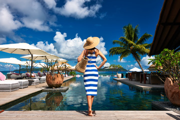 Canvas Print - Woman sailor striped in dress near poolside