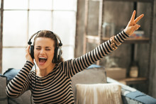 Cheerful Young Woman Listening Music In Headphones 