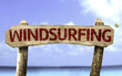 Windsurfing sign with a beach on background