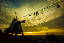 Prague Metronome, Shoes On A Wire At Romantic Sunrise