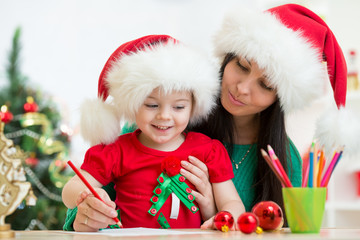 kid girl and mother writing letter to Santa