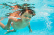 © Sergey Novikov - Close up view of small boy swimming under water