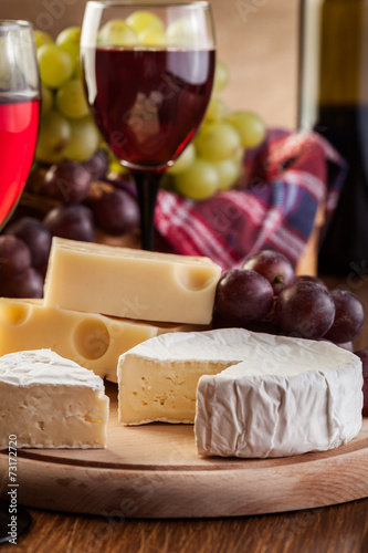 Cheese with a bottle and glasses of red wine Poster