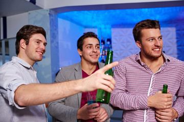 Poster - group of male friends with beer in nightclub