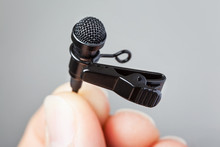 Hand Holding Tie-Clip Microphone