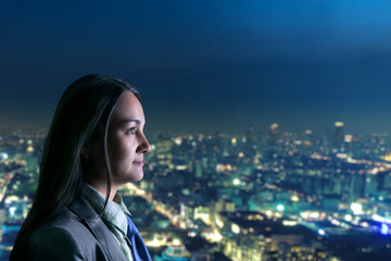 Woman looking at night city