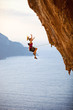 Female rock climber falling of a cliff while lead climbing