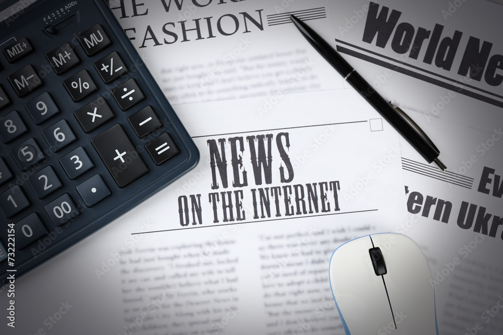 On-line news and business concept. Computer mouse, calculator
