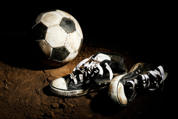 Soccer ball on ground on dark background