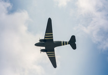 Military Airplane As Seen From The Ground Against Blue Sky