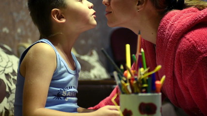 mother kissing her son