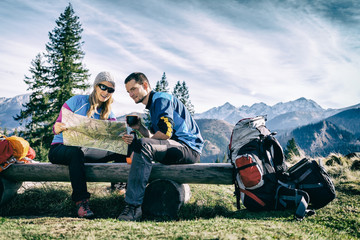 Wall Mural - Couple hikers with map vintage retro mountains