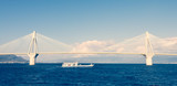 Fototapeta  - Ferry boat sailing under suspension bridge
