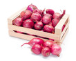 Red onions in wooden crate
