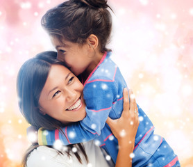 Sticker - smiling little girl and mother hugging indoors