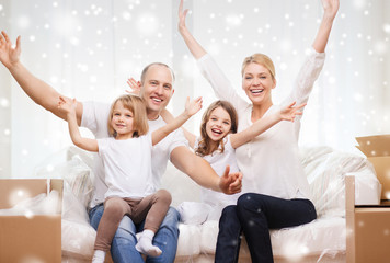 Wall Mural - smiling parents and two little girls at new home