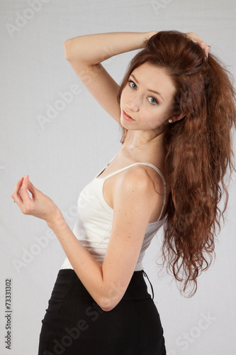 Fotografie, Obraz Woman with long hair looking thoughtfully at the camera