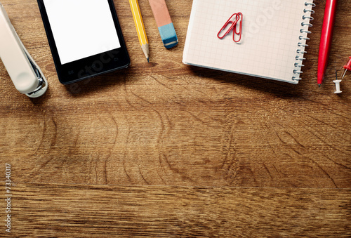 Fotografia, Obraz Office Supplies and Phone on Table at Top Edge