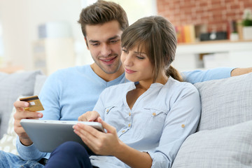 Young couple shopping on internet with tablet