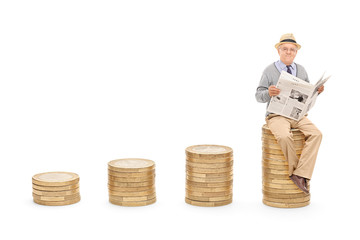 Poster - Pensioner reading the news on a pile of coins