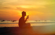 © nadezhda1906 - Silhouette of young man drinking cocktail at sunset