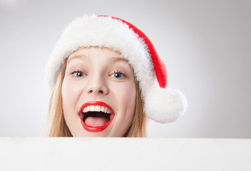 Christmas woman in santa hat holding empty board