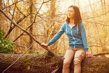 Sticker - Woman sitting on fallen tree trunk