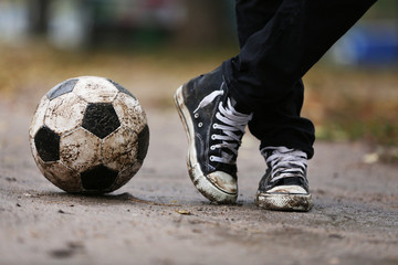 Wall Mural - Soccer ball on ground in rainy day, outdoors