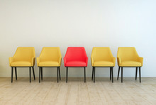 Yellow Chairs Aligned With A Red One In The Middle