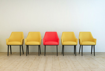 Yellow chairs aligned with a red one in the middle