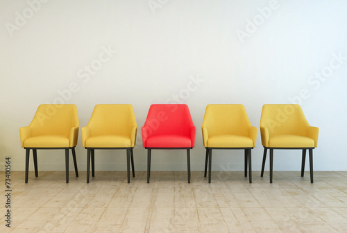 Fotografie, Obraz Yellow chairs aligned with a red one in the middle