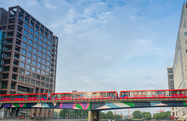 Sticker - LONDON - AUG 20, 2013: Red train crosses river between Canary Wh