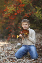 boy in a bright fall foliage park