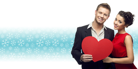 Poster - young couple holding heart over winter background