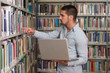 © Jale Ibrak - Happy Male Student With Laptop In Library