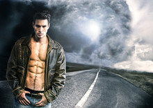 Young Man Walking Down A Road With A Storm And Very Bad Weather 