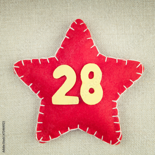 Poster Red star with wooden number 28 on vintage fabric background