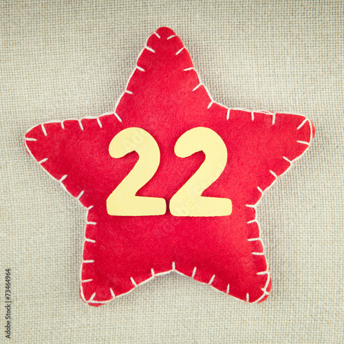 Poster Red star with wooden number 22 on vintage fabric background