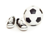 Fototapeta Sport - soccer ball and sport shoes on white
