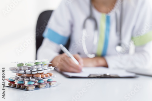 Fotografering Doctor writing many medicine prescriptions