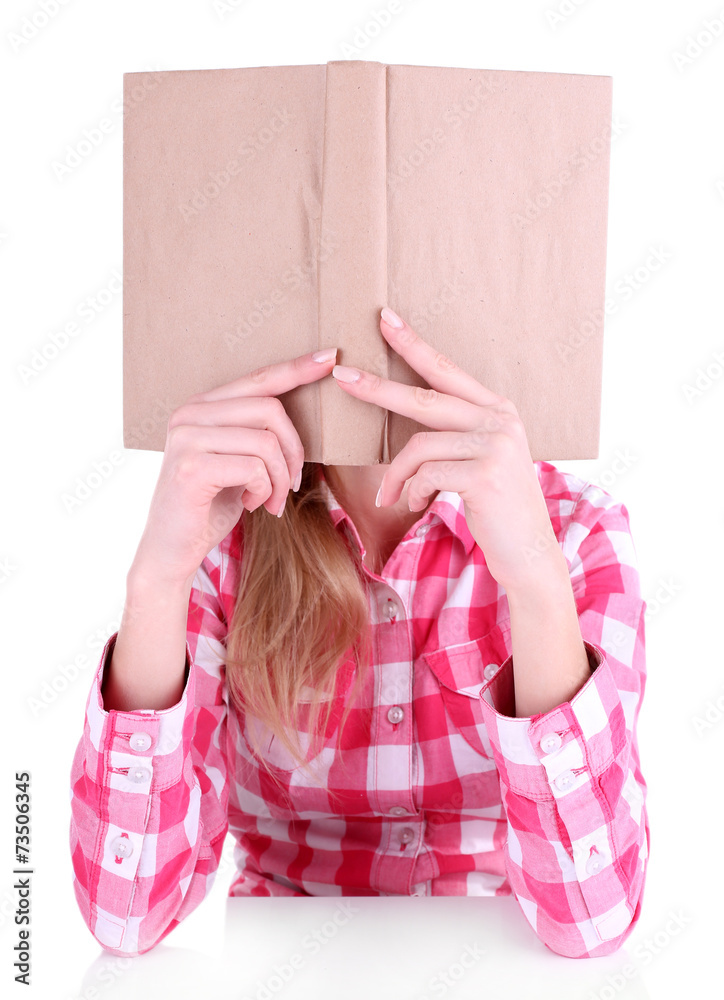 Girl reading book covering her face isolated on white
