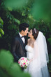 © DragonImages - Kissing wedding couple
