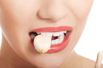 Close up on woman mouth eating garlic