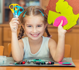 little girl is engaged in needlework